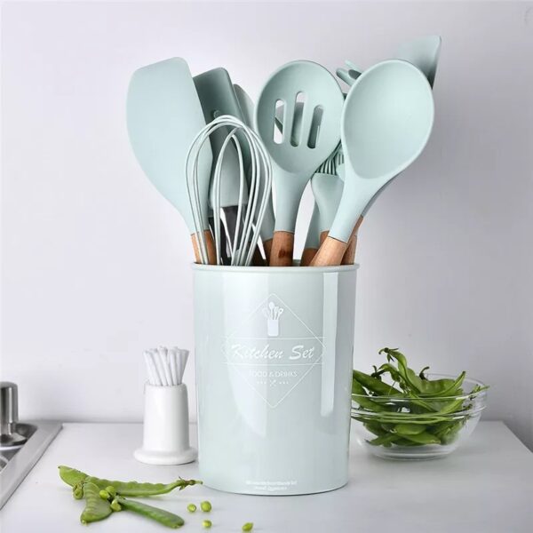 Upgrade your kitchen with the 12 PCS Silicone Cooking Tools Kitchen Utensils Set. This versatile set comes with essential kitchen accessories neatly packed in a convenient storage box. Whether you're stir frying, sautéing, or simply preparing a delicious meal, these silicone utensils are the perfect companions for your culinary adventures. Crafted from high-quality silicone, these cooking tools are designed to be environmentally friendly, non-toxic, and heat-resistant. The non-stick surface ensures easy and hassle-free cooking while protecting your cookware from scratches. The durable construction guarantees long-lasting performance, making these utensils a reliable choice for your everyday cooking needs. The ergonomic design of the utensils, coupled with the natural acacia wood handles, offers a comfortable grip and a touch of elegance. They can withstand a wide temperature range, from -40 to 230 degrees Celsius, making them suitable for use in ovens, microwaves, dishwashers, and even refrigerators. Cleaning is a breeze, as these utensils are easy to clean and can be safely boiled and sterilized. The set includes a spatula, basting brush, pointed spatula, round-edge turner, ladle, straight-edge turner, spoon, tongs, and pasta fork, catering to all your cooking needs. The vibrant color options of green and black add a stylish touch to your kitchen decor. Upgrade your cooking experience with this versatile and durable 12 PCS Silicone Cooking Tools Kitchen Utensils Set. Explore new recipes, enjoy hassle-free cooking, and elevate your kitchen to new heights of convenience and style.